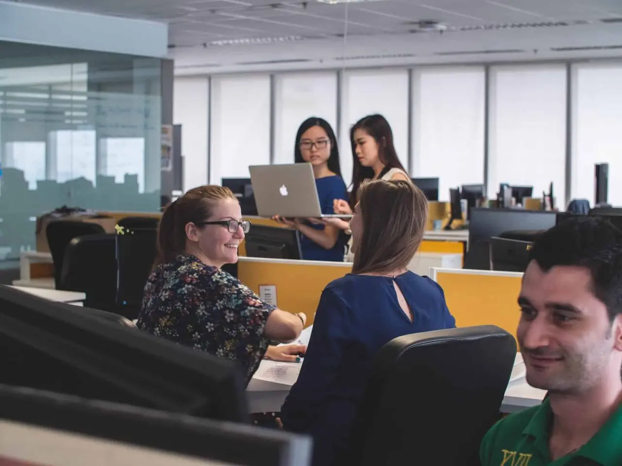 A workplace team collaborating in a busy office