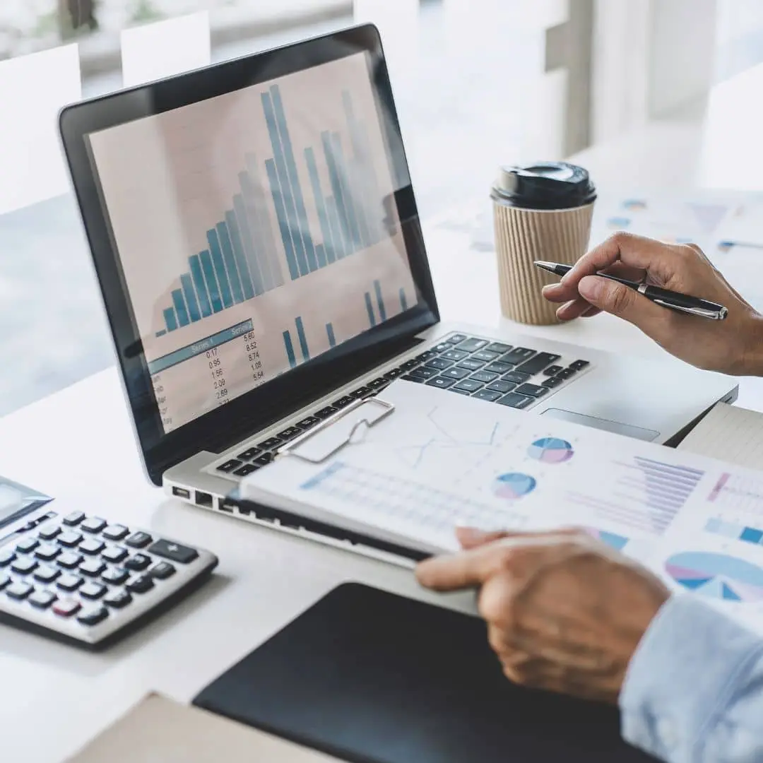 Reviewing workforce hours and costs on a laptop