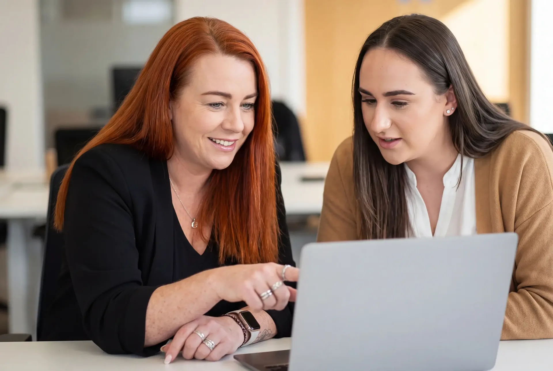 Two PurpleTree HR advisors reviewing a client's case together at a laptop